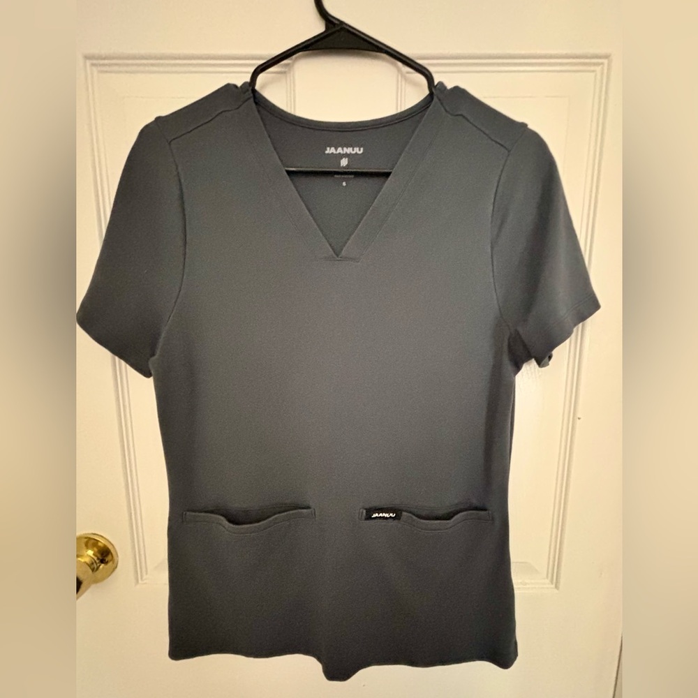 This is a Jaanuu, size small scub top